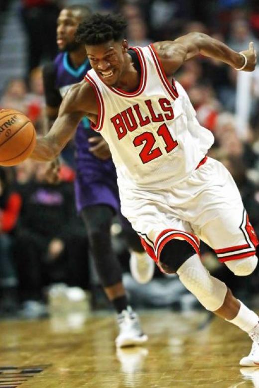Jimmy Butler #21 of the Chicago Bulls chases down a loose ball against the Charlotte Hornets
