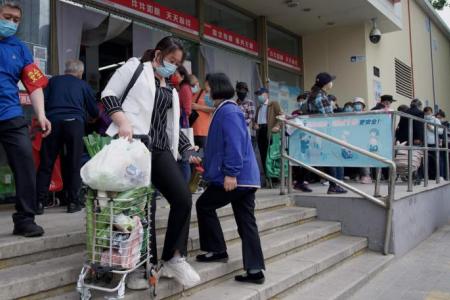 Beijing Covid-19 spike prompts mass testing, panic buying