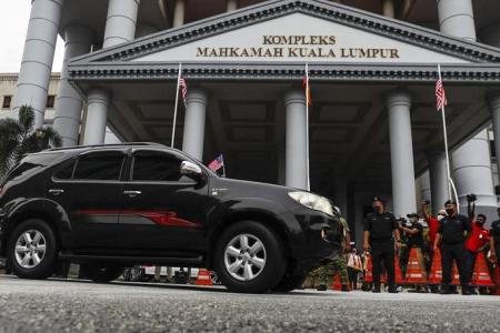 Questions raised over Najib's suit and ride to court