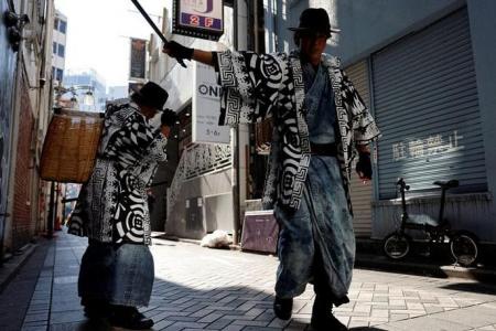 Samurai trash collectors clean Tokyo streets after Halloween revels