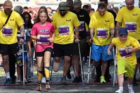 Girl, 12, who lost legs in Russian missile attack, runs at Ukraine city half-marathon
