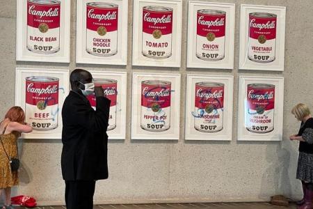 Climate activists glue themselves to Warhol artwork in Australian capital