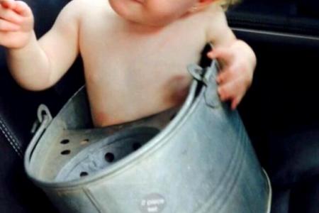 Baby gets stuck in a mop bucket