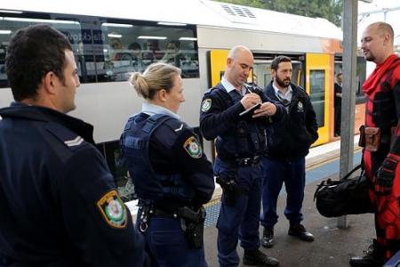 Armed 'superhero' hauled off train by cops 