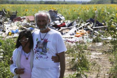 Heartbroken victim's parents visit MH17 site