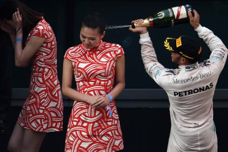 Lewis Hamilton slammed for spraying champagne on hostess. She says...