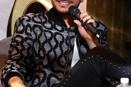 US singer Adam Lambert says 'wild displays' are in the past