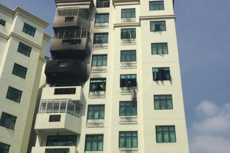 Fire at condominium traps family in bedroom