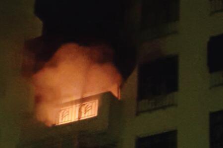 Fire at condominium traps family in bedroom