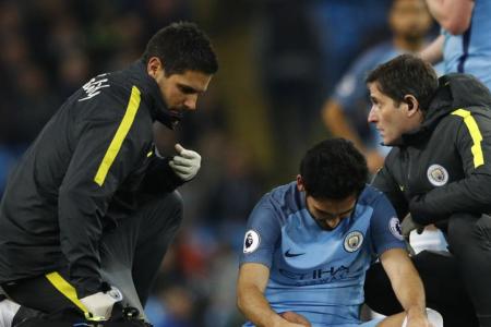 Manchester City&#039;s Ilkay Gundogan receives treatment after sustaining a injury