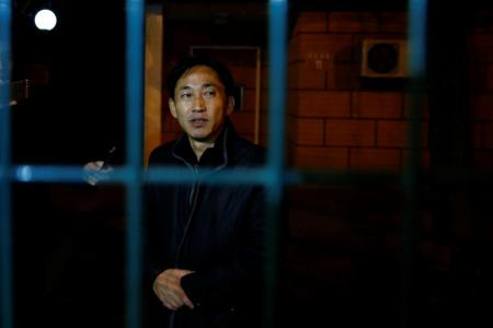 North Korean national Ri Jong Chol stands behind the fence of the North Korean embassy compound in Beijing, China
