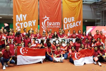 Minister for Culture, Community and Youth Grace Fu (centre, in white pants) poses with able-bodied and para-athletes at the Team Singapore camp at the Singapore Sports Institute in Kallang on Saturday, after launching the #OneTeamSG Ready for KL campaign.