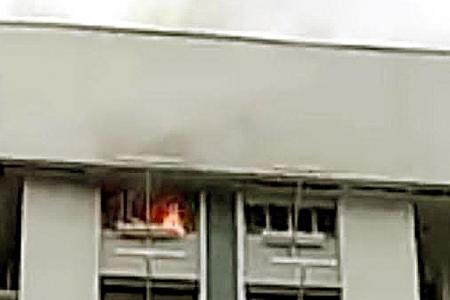 Neighbours struggle to persuade man to leave his burning flat