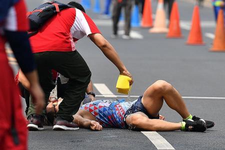Walker collapses after 50km of heat, smog and humidity
