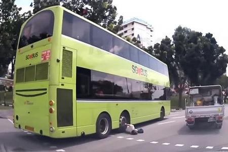 Woman taken to hospital after being pinned under SBS bus