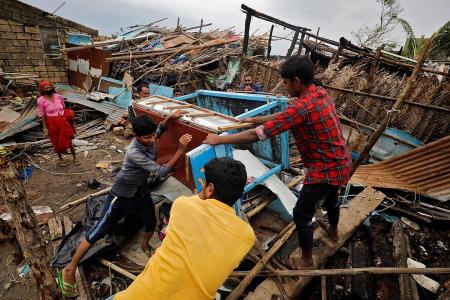 India reports record Covid deaths as cyclone complicates efforts