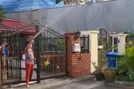 Woman hoses down debt collectors at her front gate