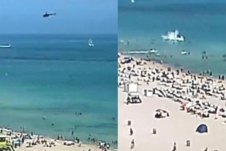 Near miss for Florida beachgoers as helicopter crashes in the sea, injuring two on board