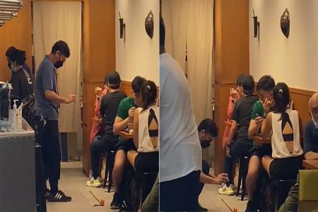 Safe distancing ambassador turns heads with measuring tape at VivoCity eatery