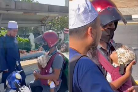 Delivery rider carrying baby during work touches hearts of Malaysians