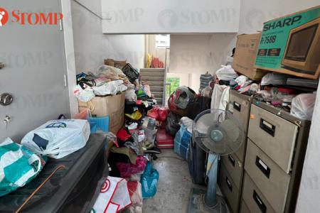 Man nearly falls down the stairs while trying to navigate clutter