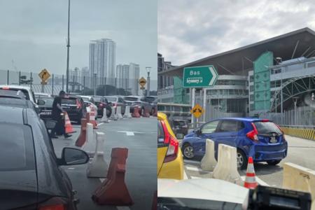 S'pore drivers move barricades to cut queue at Causeway