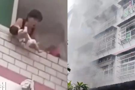 'Please save my baby!': Woman in China throws baby out of burning flat