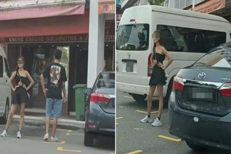 Woman 'chopes' parking space in Chinatown with hands on hips, shooing vehicles away