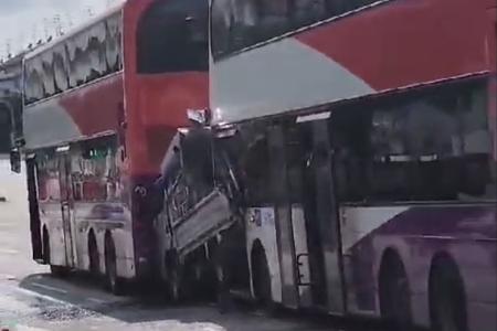 Pick-up truck sandwiched between buses at Loyang Ave