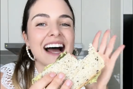 Woman adds chopped petai to her avocado toast