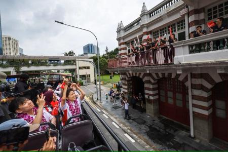 Thousands cheer on Paralympians in celebratory bus parade