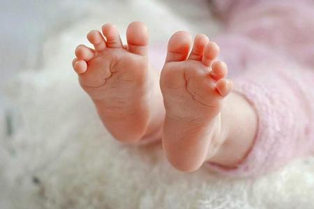 Abandoned newborn covered with ants at a bus stop in Taiping