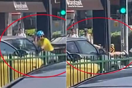 Two women arrested after cyclist jumps onto moving car’s bonnet