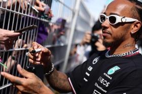 Mercedes driver Lewis Hamilton signs autographs on the Circuit de Monaco in Monte Carlo.