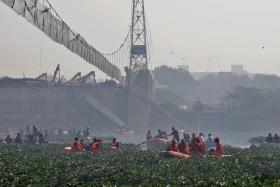 Rescuers search for survivors after the collapse of the suspension bridge in Gujarat, on Oct 31, 2022.