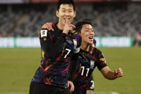 South Korea captain Son Heung-min celebrates with Hwang Hee-chan after scoring the first goal against China.