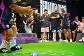 Bayern Munich player Serge Gnabry (right) playing a game with fans during an event at the Adidas Brand Centre Orchard on July 31.