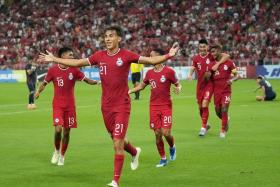 Jacob Mahler celebrates with teammates after scoring Singapore&#039;s second goal in the 2-0 win over Guam.