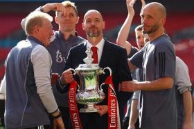 Manchester United manager Erik ten Hag and his backroom staff with the FA Cup trophy after beating Manchester City 2-1 on May 25.