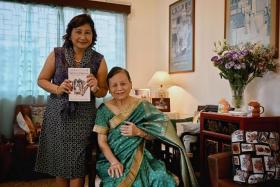 Social scientist Theresa Devasahayam posing with her book and her mother, Mrs Jane Devasahayam, who was adopted.