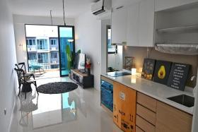 The kitchen and living room of a two-bedroom unit at the Treasure at Tampines condominium.