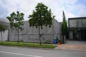 The 1,816.3 sq m site (left, covered by sound barrier) at 69 Ocean Drive in Sentosa Cove, offers unblocked views of the sea and the Central Business District.