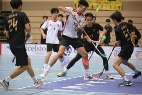 Victoria Junior College's Gerald Tan (centre in white) scored the winning penalty in the A Division boys' floorball final.