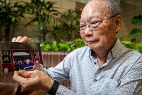 Mr Kong Fook Seng with a photo of himself and his late father Kong Wing Hing during a trip to China.