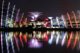 The cloud forest, Supertrees and flower dome being illuminated in red and white at Gardens by the Bay, on June 28, 2024.