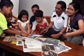 Former footballer Rahmat Mawar showing newspaper clippings and photos of his playing days to his grandchildren. He was the captain of the formidable Singapore Malays team and led it to two Sultan Gold Cups, in 1973 and 1975.