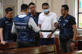 The suspect, Basnayake Keith Spencer, back at the scene at St Joseph's Church in Bukit Timah on Dec 6.