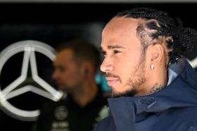 Mercedes driver Lewis Hamilton arriving in the garage ahead of the first practice session of the Bahrain Formula One Grand Prix.