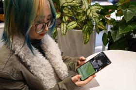Ms Wang Xiuting showing her virtual boyfriend on Wantalk - an artificial intelligence chatbot created by Chinese tech company Baidu.
