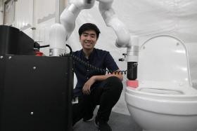 Co-founder and COO of Hivebotics Tuan Dung Nguyen with the company's toilet cleaning robot which is being tested by JTC in industrial parks.
